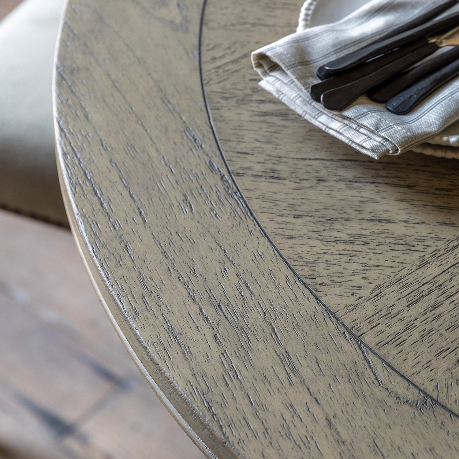 Close-up detail of Faringdon Round Dining Table's inlaid parquet wood pattern, highlighting the natural grain and artisanal craftsmanship