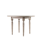 Side angle of Faringdon Round Dining Table displaying the ornate turned legs and solid construction, showcasing its craftsmanship and stability