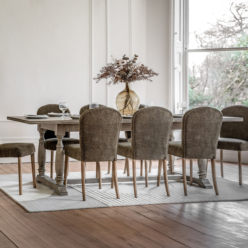 Faringdon Extending Dining Table in a styled dining room setting with chairs, demonstrating its proportions and how it fits in a complete dining arrangement.