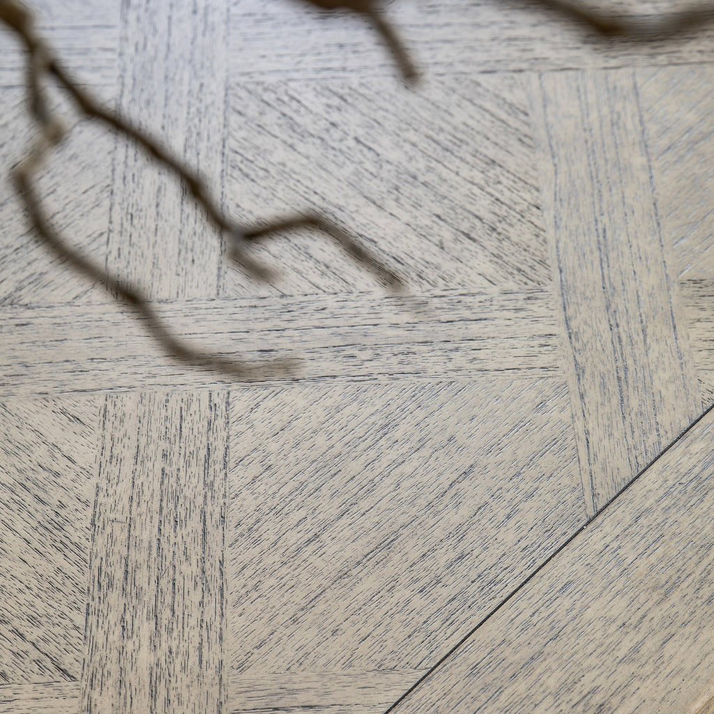 Overhead view of Faringdon Extending Dining Table's parquet wood pattern, revealing the natural grain variations and detailed inlay design