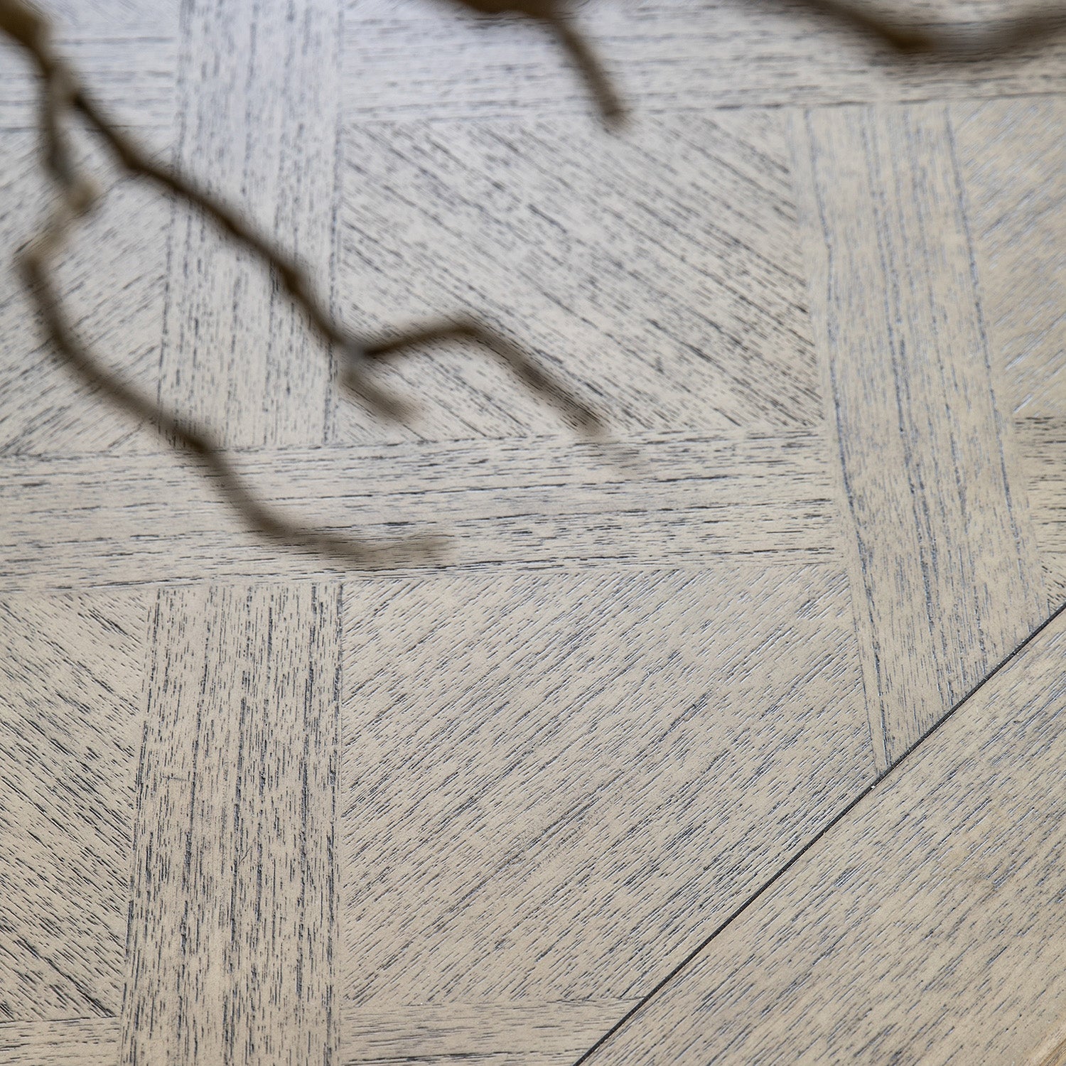Overhead view of Faringdon Extending Dining Table's parquet wood pattern, revealing the natural grain variations and detailed inlay design