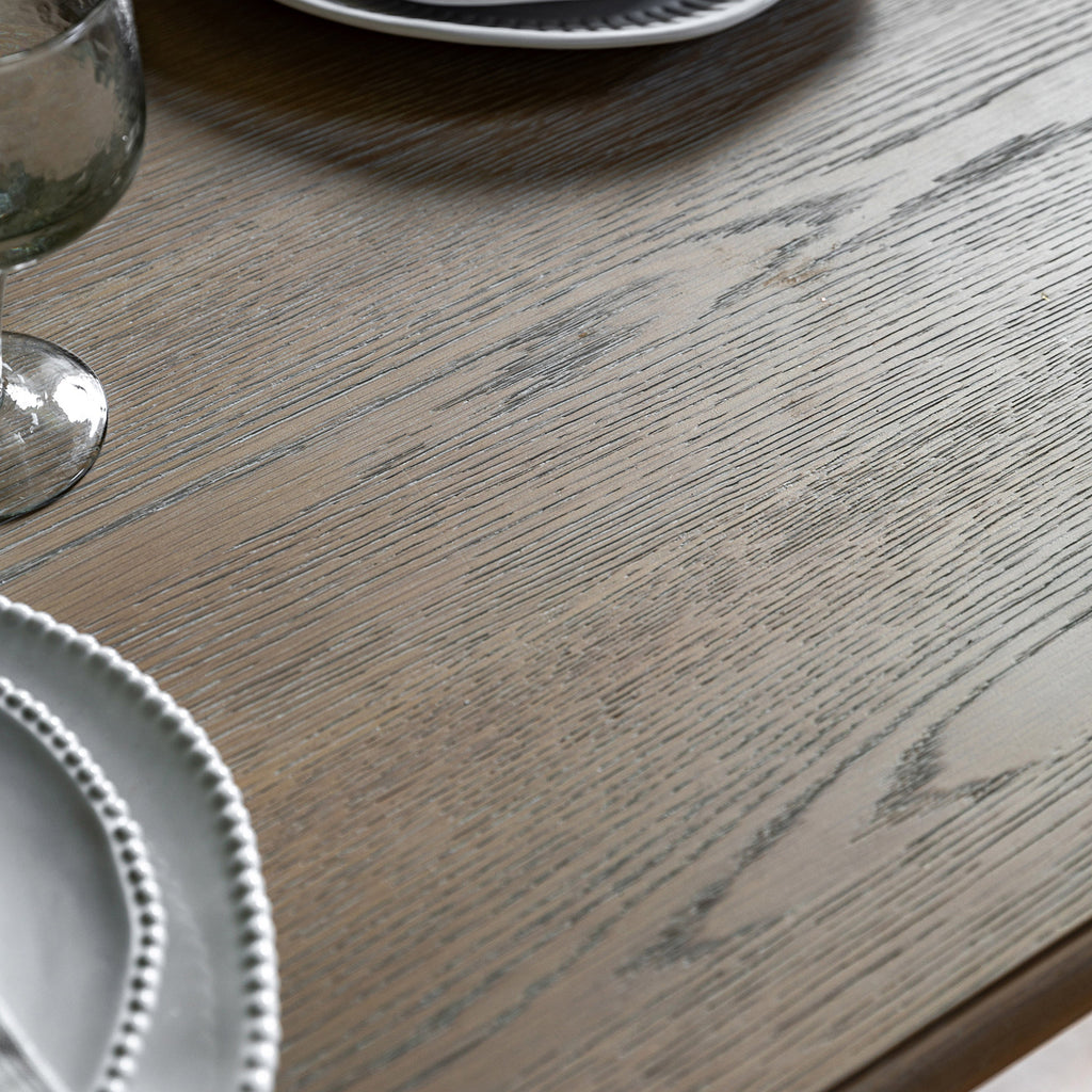 Detail shot of the Wallingford Extending Dining Table's wood finish, showing the texture and warm tones of the natural wood.