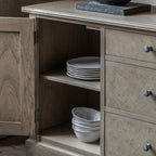 Detail view of Faringdon Sideboard's drawer and door hardware, showing the brass handles and hinges that complement the natural wood finish