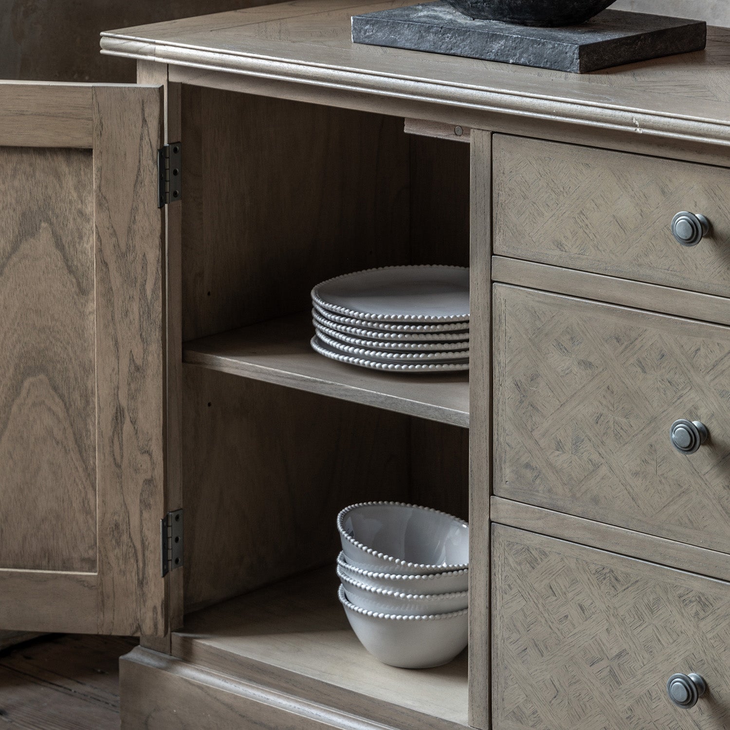 Detail view of Faringdon Sideboard's drawer and door hardware, showing the brass handles and hinges that complement the natural wood finish