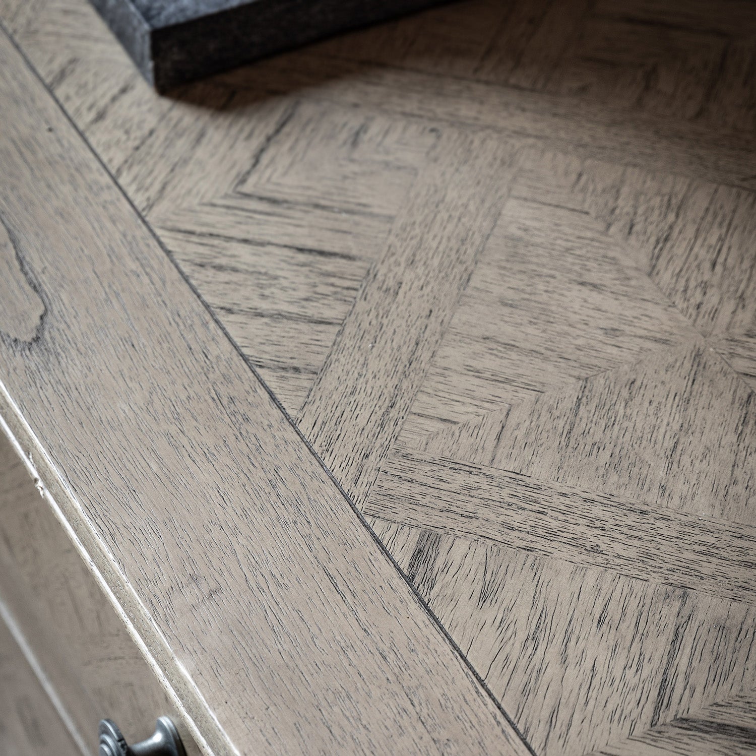 Close-up detail of Faringdon Sideboard's parquet wood pattern top, highlighting the natural grain variations and craftsmanship of the inlaid design