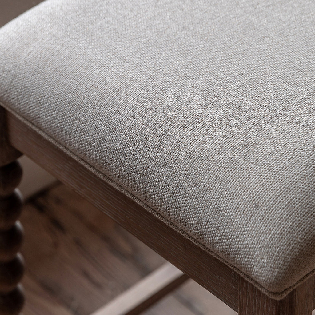 Close-up detail of Wallingford Bar Stool's seat upholstery, highlighting the texture, stitching, and quality finish