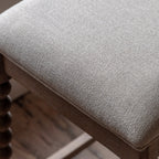 Close-up detail of Wallingford Bar Stool's seat upholstery, highlighting the texture, stitching, and quality finish