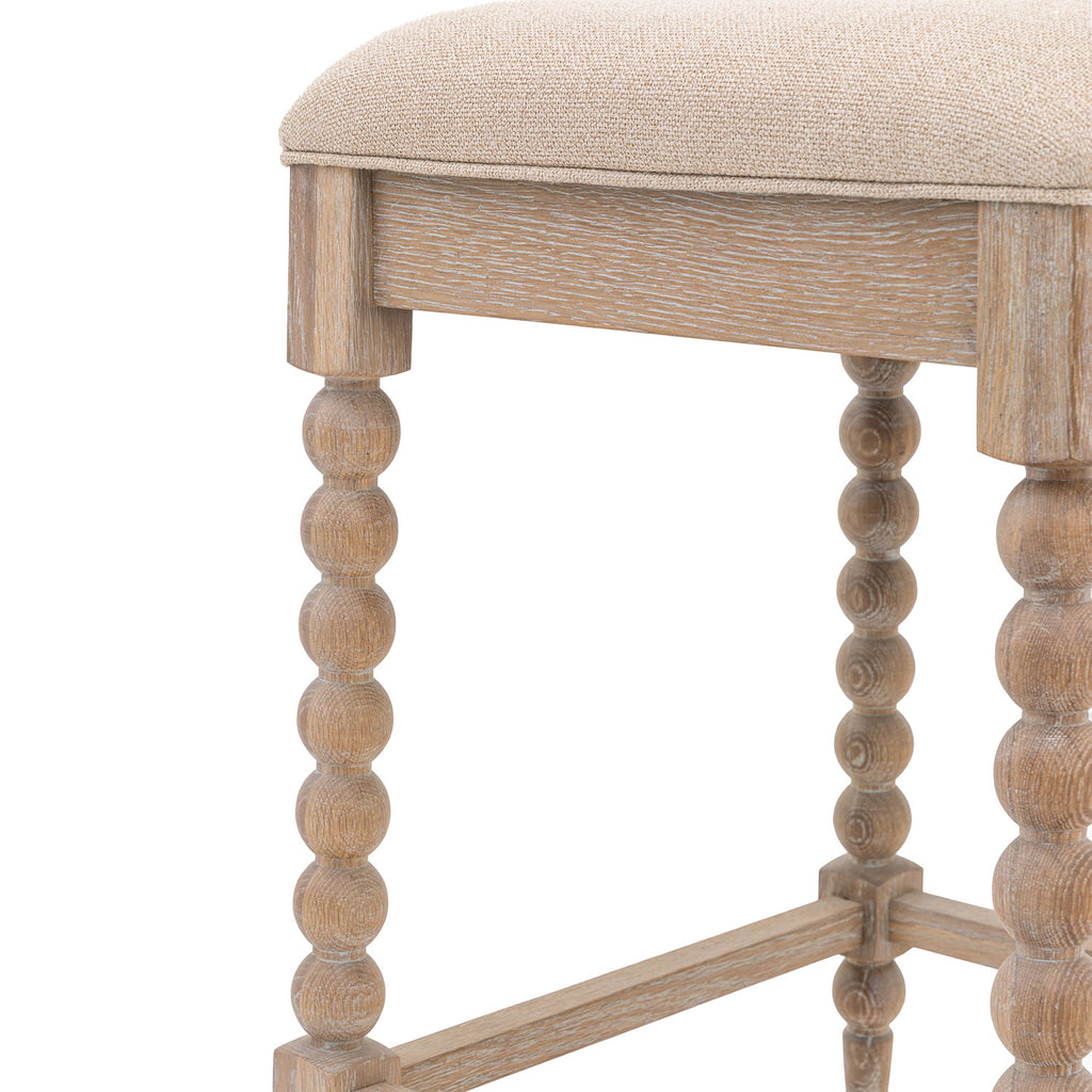 Detail view of Wallingford Bar Stool's wooden frame, showing the natural grain variations, finish quality, and structural design elements