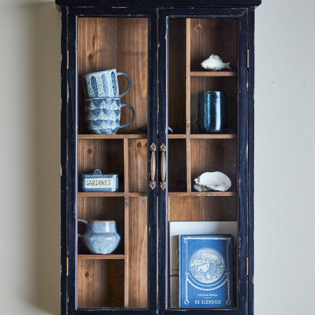 Minimalist black cabinet featuring clean design and ample storage for modern living spaces.