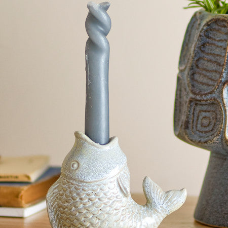 Decorative fish candle holder placed on a table