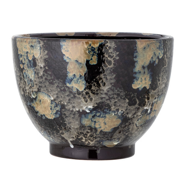 Ceramic pot with blue glaze on a white background