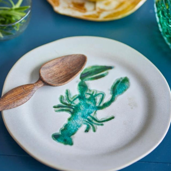 White ceramic lobster plate with striking green lobster graphic, ideal for seafood lovers and nautical table décor.