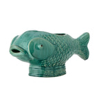 Green fish-shaped ceramic planter placed on a white background