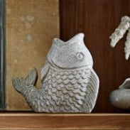 Unique fish candle holder holding a small tealight candle.