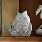 Unique fish candle holder holding a small tealight candle.