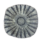 Stoneware serving plates arranged on a dining table with food