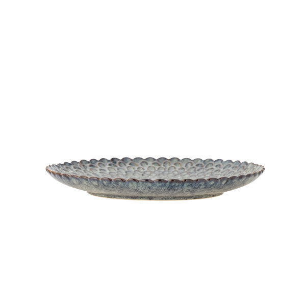 Grey dinner plates styled as a table centrepiece in a minimalist home