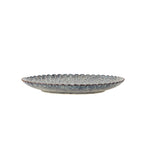 Grey dinner plates styled as a table centrepiece in a minimalist home