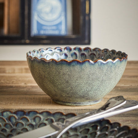 Ceramic bowl with textured rim on a wooden surface