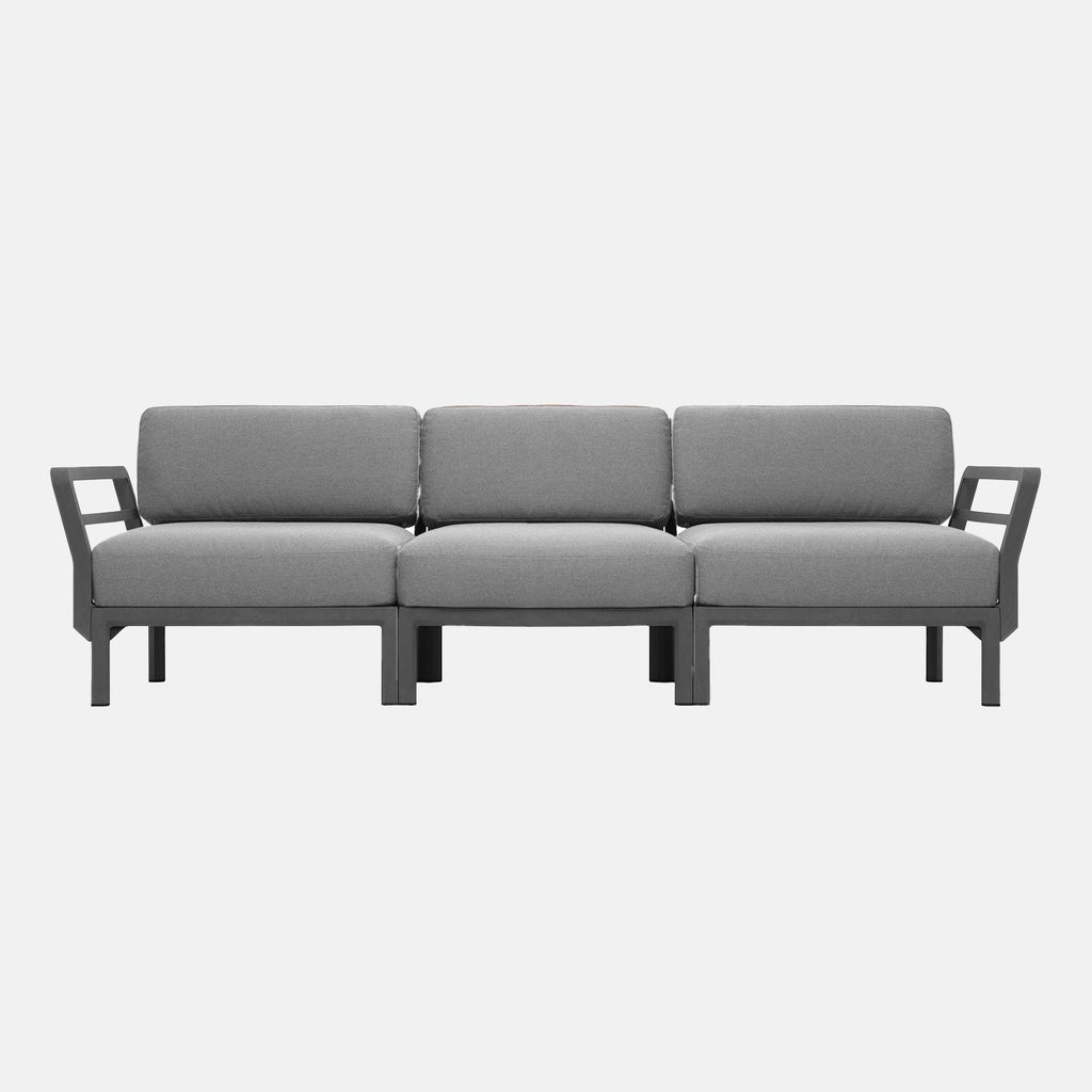 Grey outdoor sofa with armrests on a white background, seats 3 people
