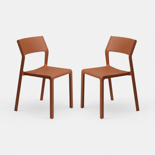 Two mattone colour trill chairs on a white background