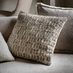 Textured pillows on a sofa with a neutral colour palette