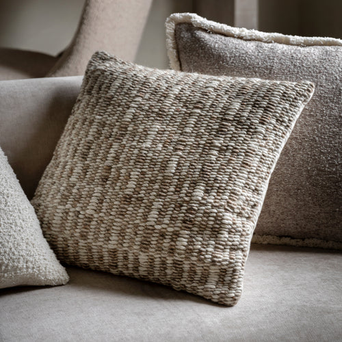 Textured pillows on a sofa with a neutral colour palette