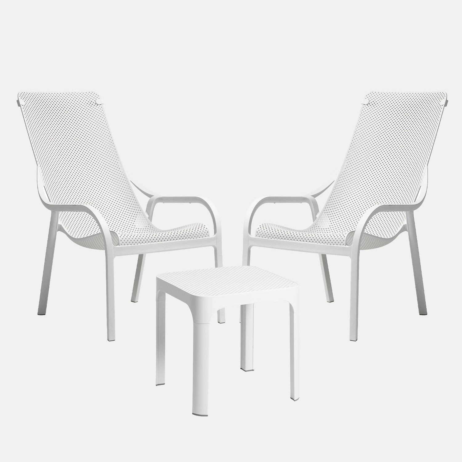 White outdoor chairs and table set on a light grey background