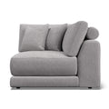 Willa - A light gray upholstered armchair with a low, chunky base, a rounded right armrest, and three matching back cushions, shown on a plain white background.