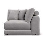 Willa - A light gray upholstered armchair with a low, chunky base, a rounded right armrest, and three matching back cushions, shown on a plain white background.