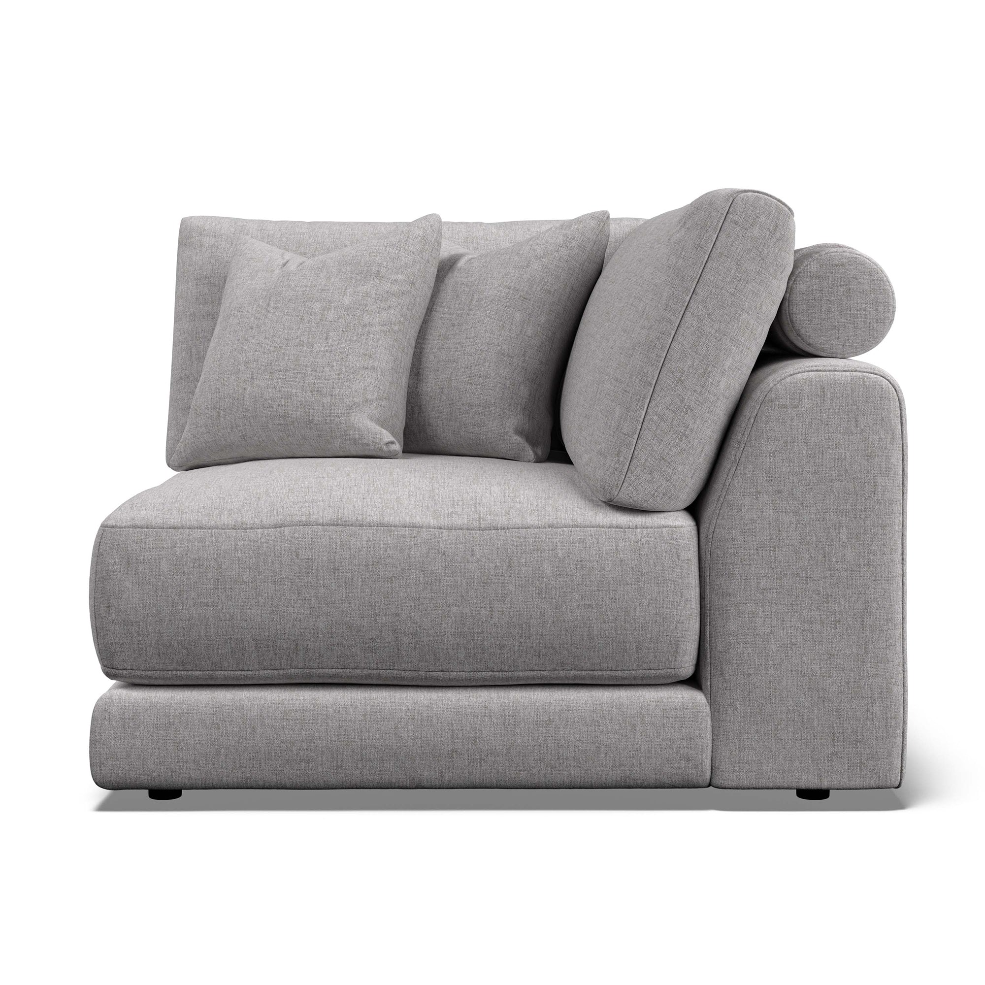 Willa - A light gray upholstered armchair with a low, chunky base, a rounded right armrest, and three matching back cushions, shown on a plain white background.