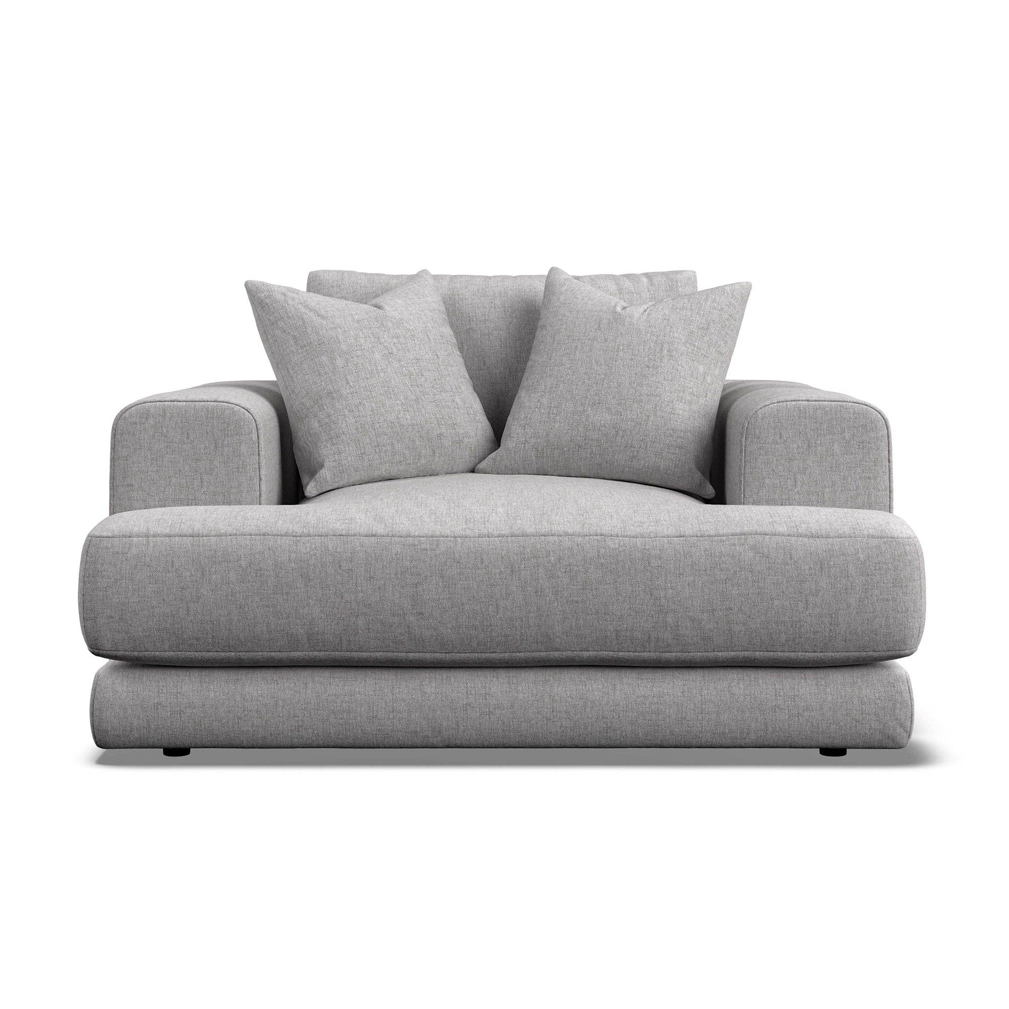 A modern low-profile armchair in light gray textured fabric, featuring two matching throw pillows, shown against a plain white background.
