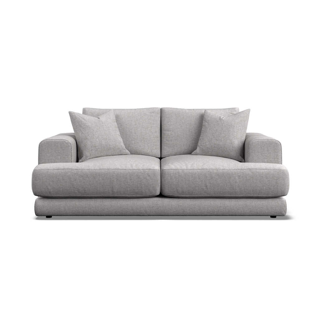 A modern two-seater sofa in light gray textured fabric, featuring two matching throw pillows, shown from a front-facing perspective on a solid white background.