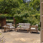 Sofa, chair and coffee table outdoor set in a garden setting on a sunny day