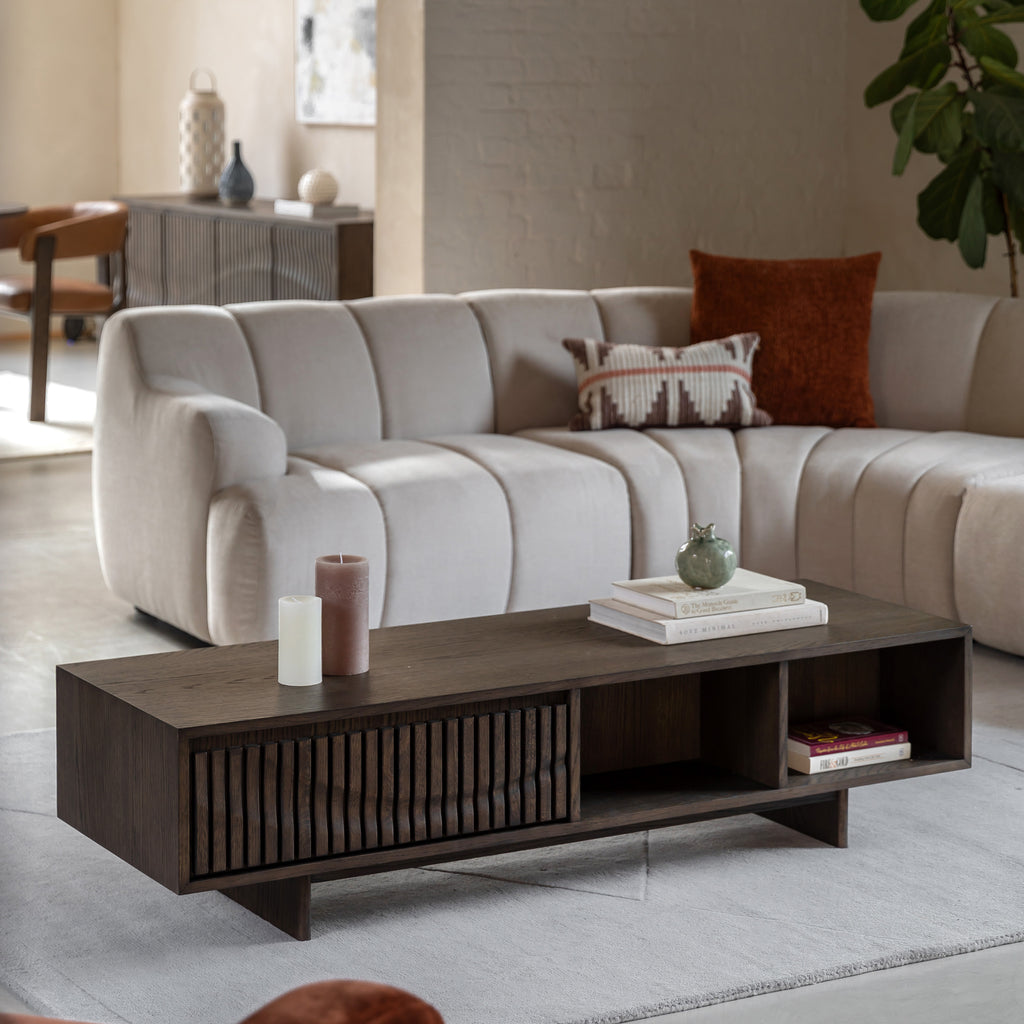 Living room with a grey sectional sofa and walnut coffee table.
