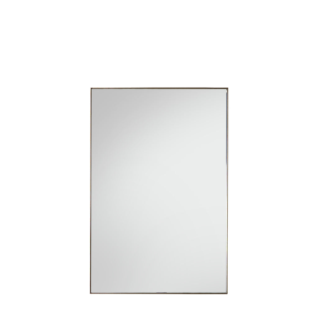 bronze rectangular mirror reflecting natural light in modern interior