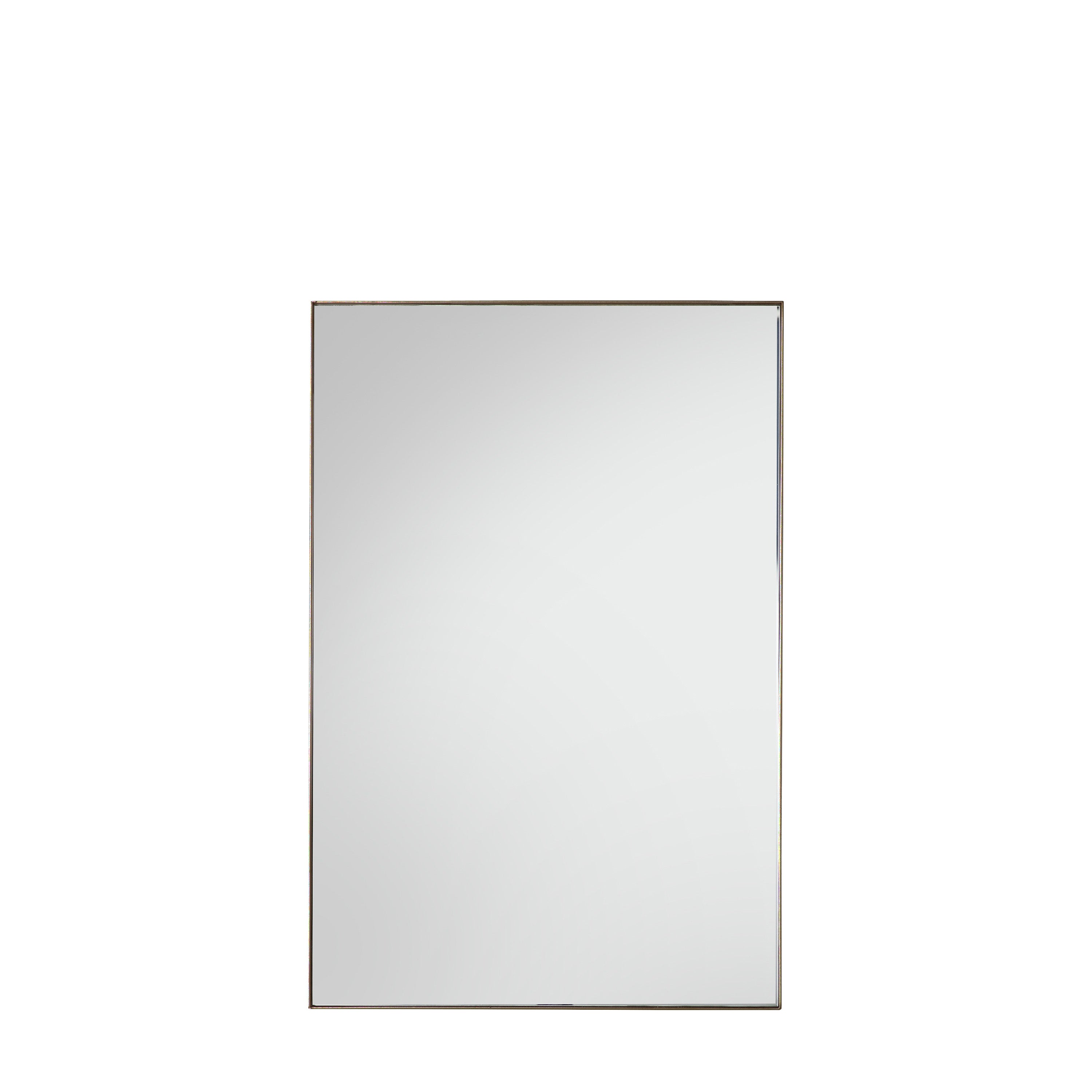 bronze rectangular mirror reflecting natural light in modern interior