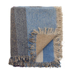 Blue throw blanket with cozy texture for sofa or bed styling.