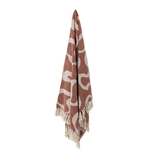 Woven throw with a wavy pattern with a white background