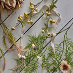 Decorative arrangement of flowers and ribbons on a textured surface