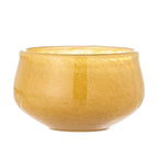 “Round yellow candle holder with smooth finish designed for table decor.