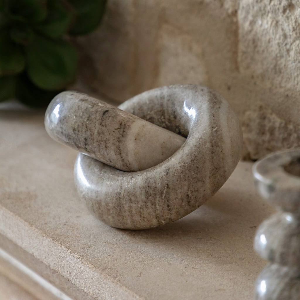 Round marble chain link in minimalist interior