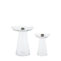 Two clear glass candle holders with metallic bases on a white background