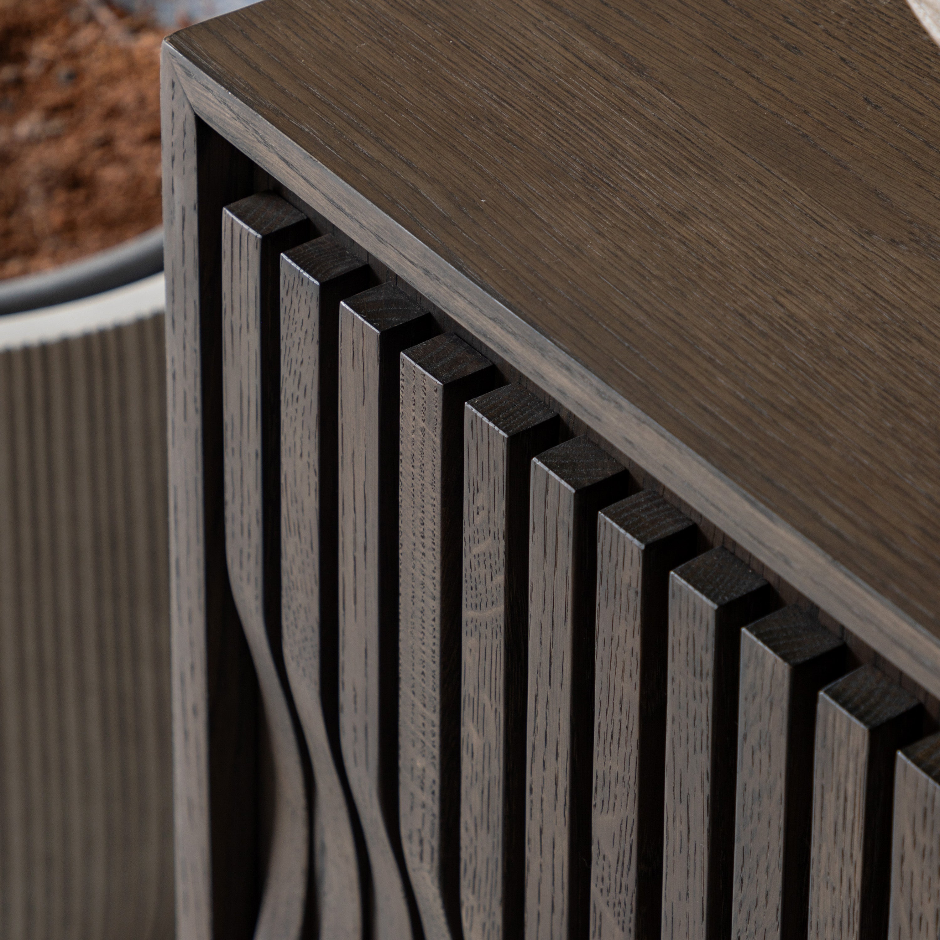 Sideboard with slatted design on a blurred natural background