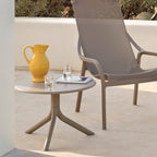 Taupe Spritz garden accent table, next to the net lounge chair.