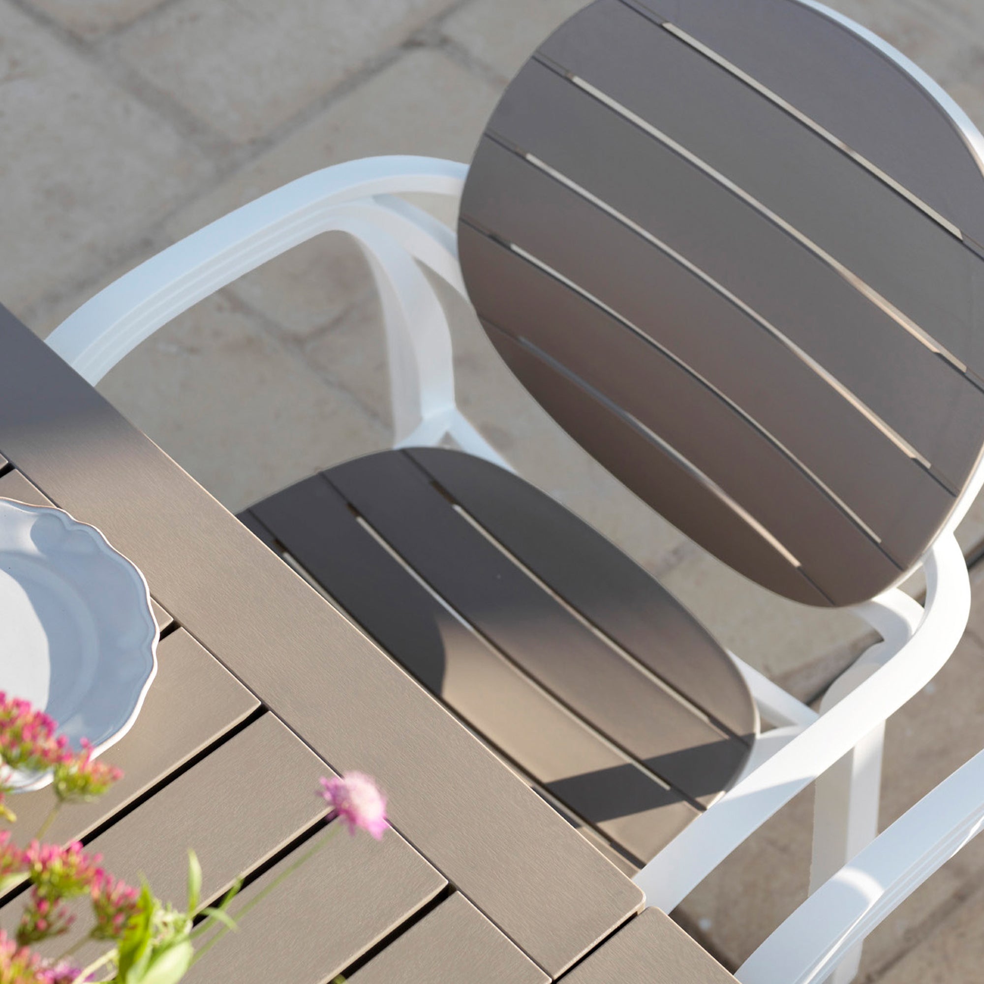Brown outdoor chair on a wooden deck with a blurred background