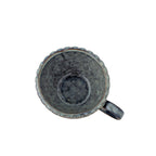 Grey cup for coffee or tea styled in a contemporary home setting