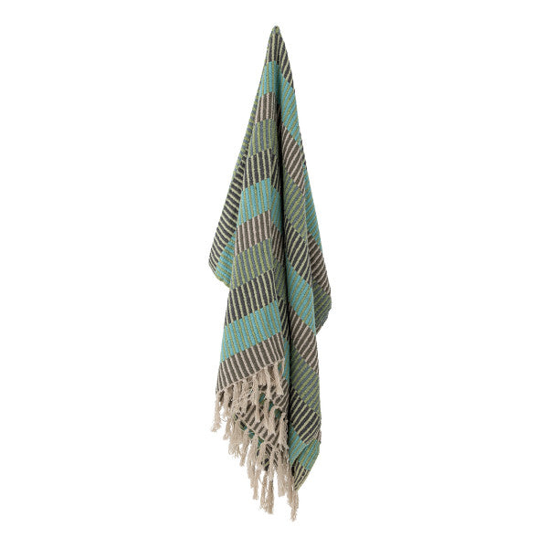 Throw blanket with tassels on a white background, with the colours white and green