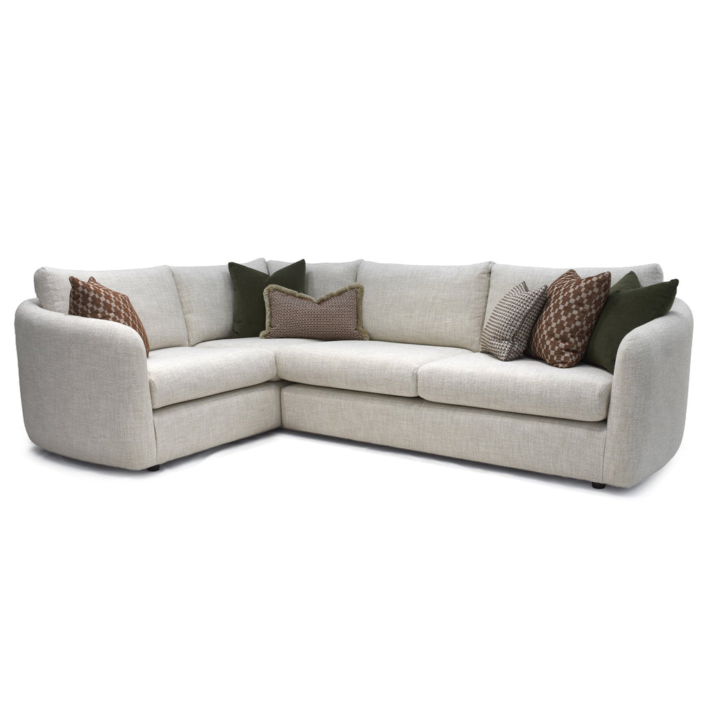  Carnaby Right Hand Facing Large Corner Sofa In Soft Boucle Oatmeal sectional sofa with patterned cushions on a white background
