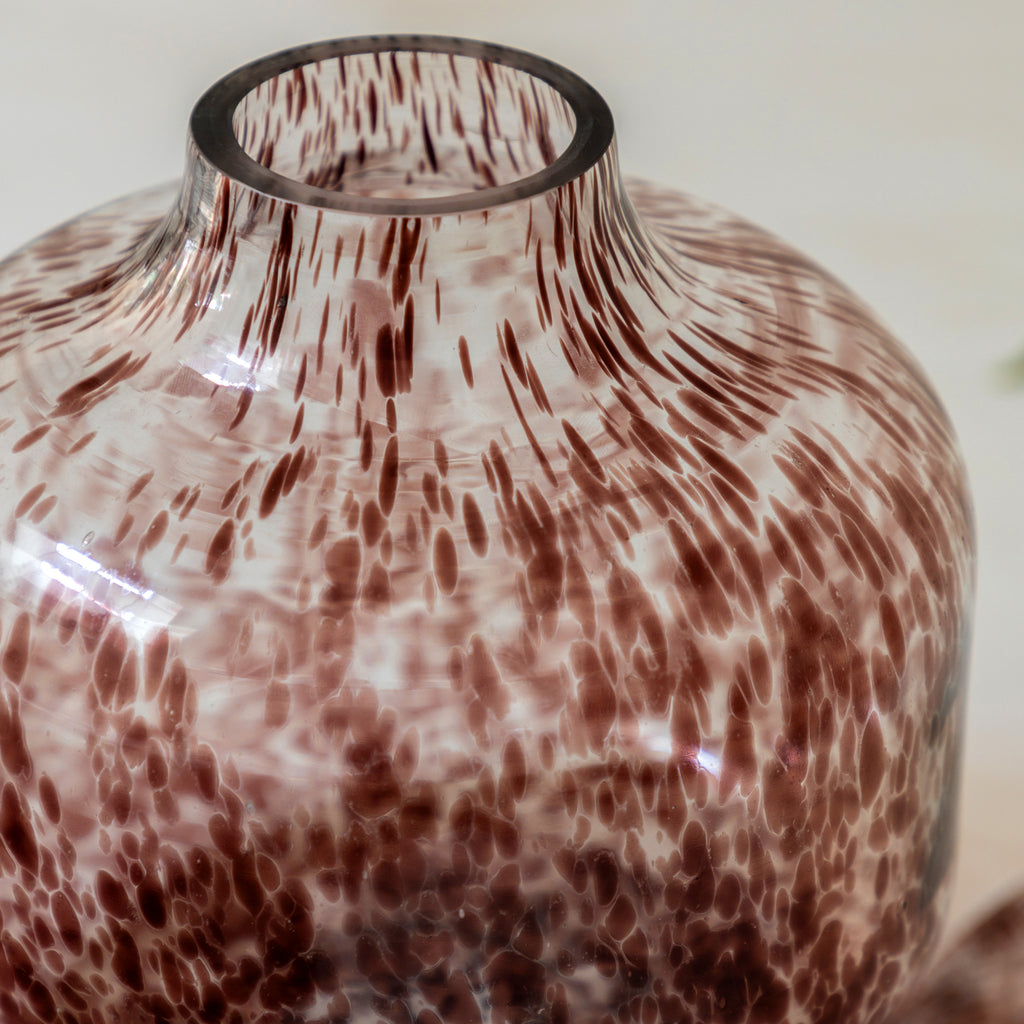 Brown vase styled with neutral home d√©cor